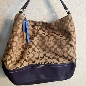 Medium size coach bag, color, tan with purple bottom and strap, purple inside